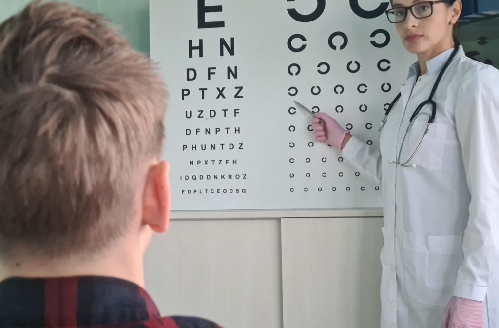 A child taking an eye test to determine what prescription they need for their myopia.