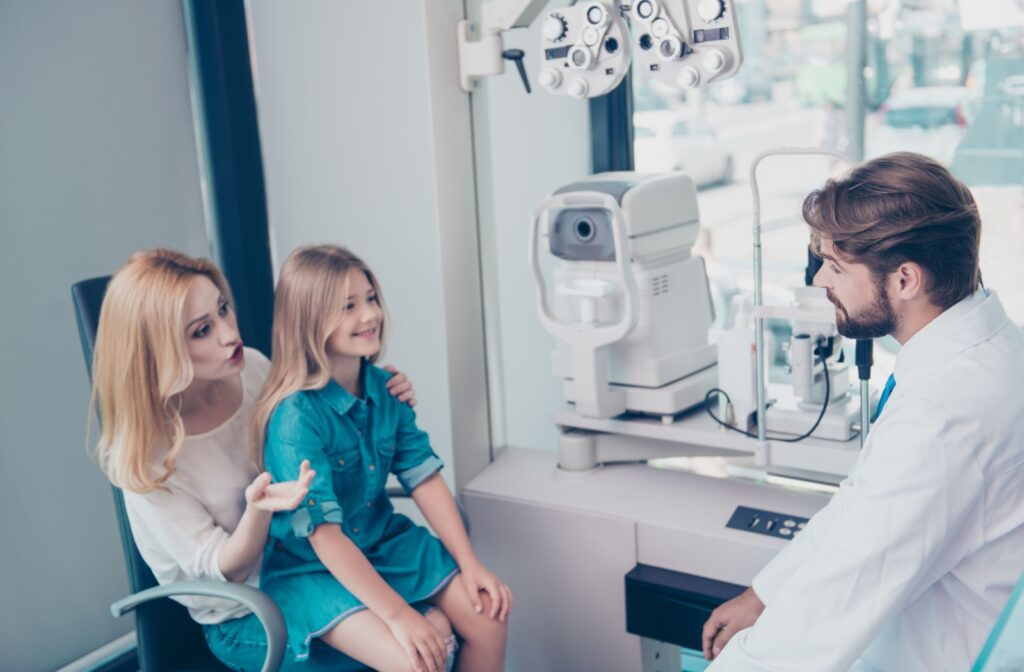 An optometrist discusses myopia control therapies with a young patient and their parent.