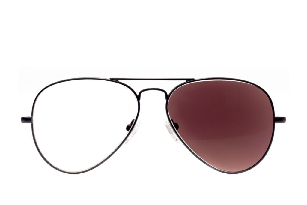 Aviator eyeglasses showing photochromic lens technology with one clear lens and one darkened tinted lens